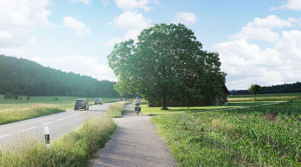 Auf einer Landstrasse sind Autos und ein Velofahrer unterwegs.